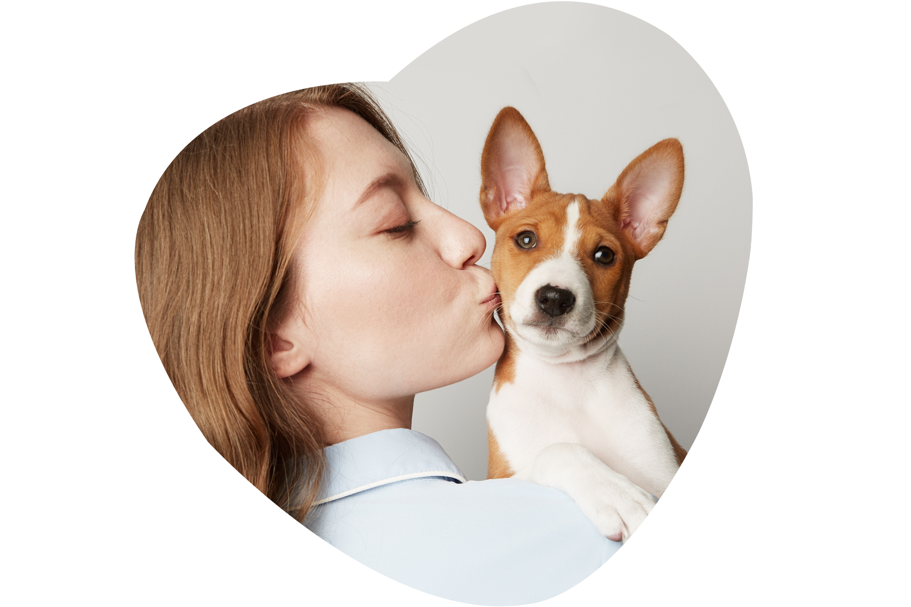 Woman kissing her puppy